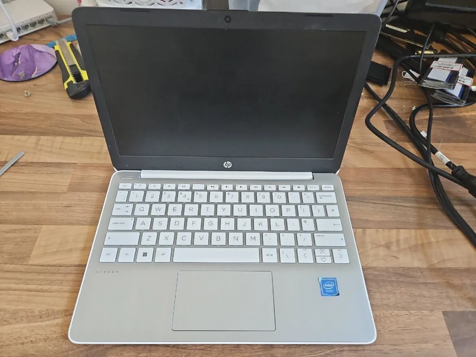 Real HP Stream laptop received for battery diagnosis at the PC Repair Guru workshop in Birmingham HP Stream laptop on a repair bench before battery diagnosis in Birmingham