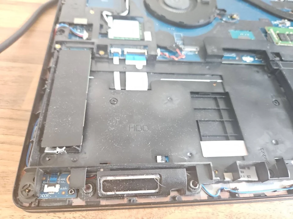 Internal laptop speaker photographed with the lower cover removed