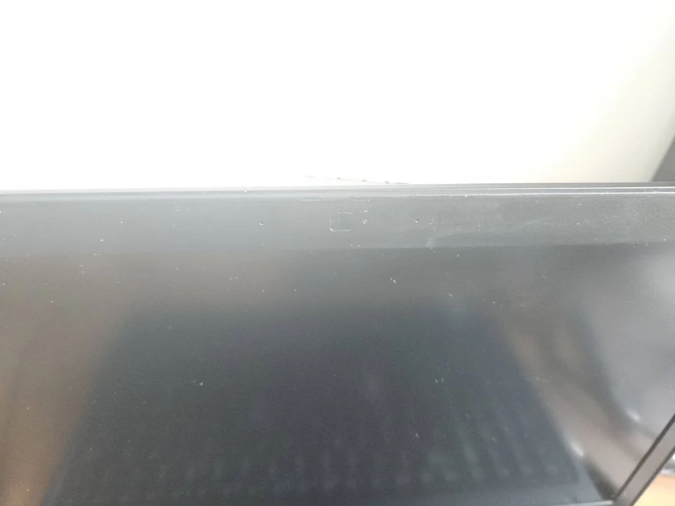 Laptop display bezel and built-in webcam photographed during inspection