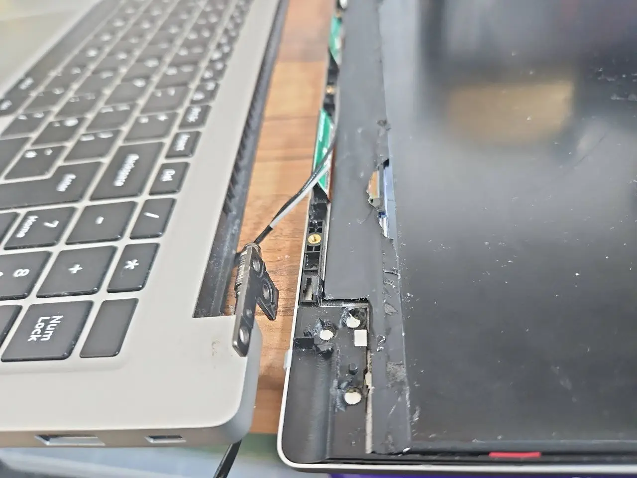 Broken laptop hinge and separated screen frame before repair in Birmingham