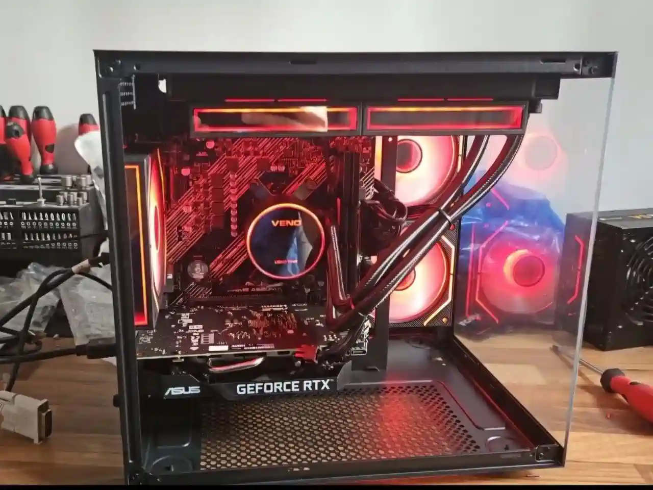 Custom gaming PC on the repair bench during cable routing, hardware checks and final inspection