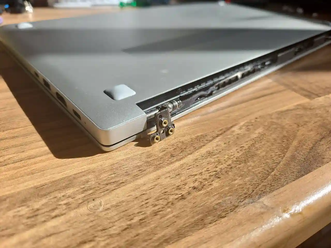Laptop hinge repair in Birmingham showing broken laptop hinge and screen casing damage inspected by PC Repair Guru