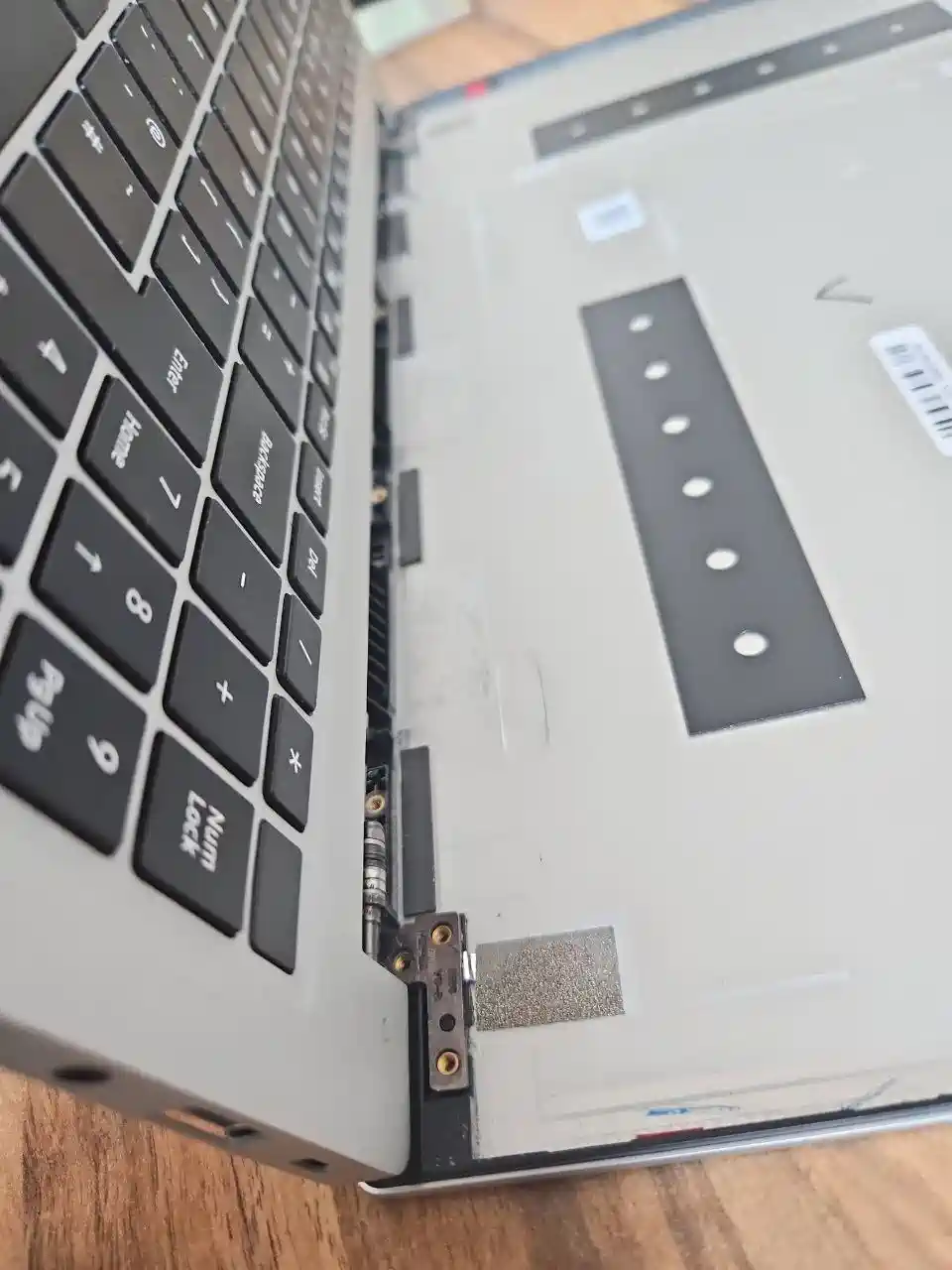 Laptop hinge repair on the workbench with hinge and casing checked by PC Repair Guru